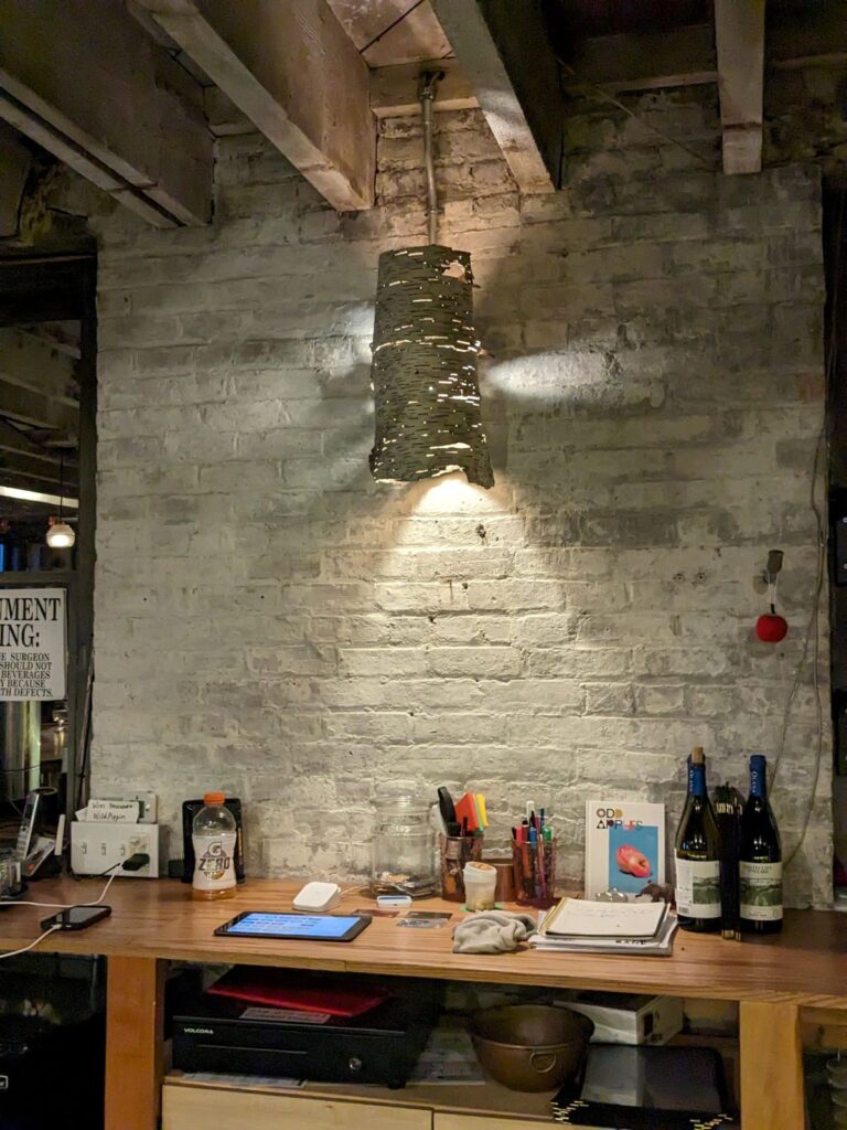 Cool white birch lampshade hanging over the bar.