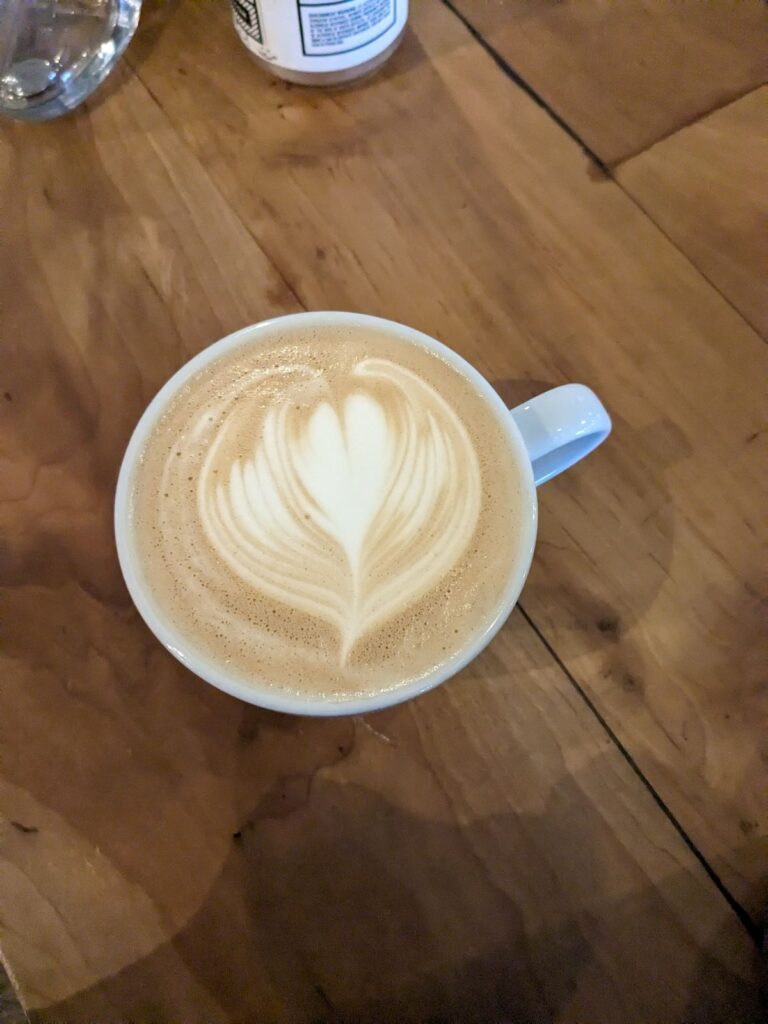 Cup of Pistachio Latte with a heart in the foam.