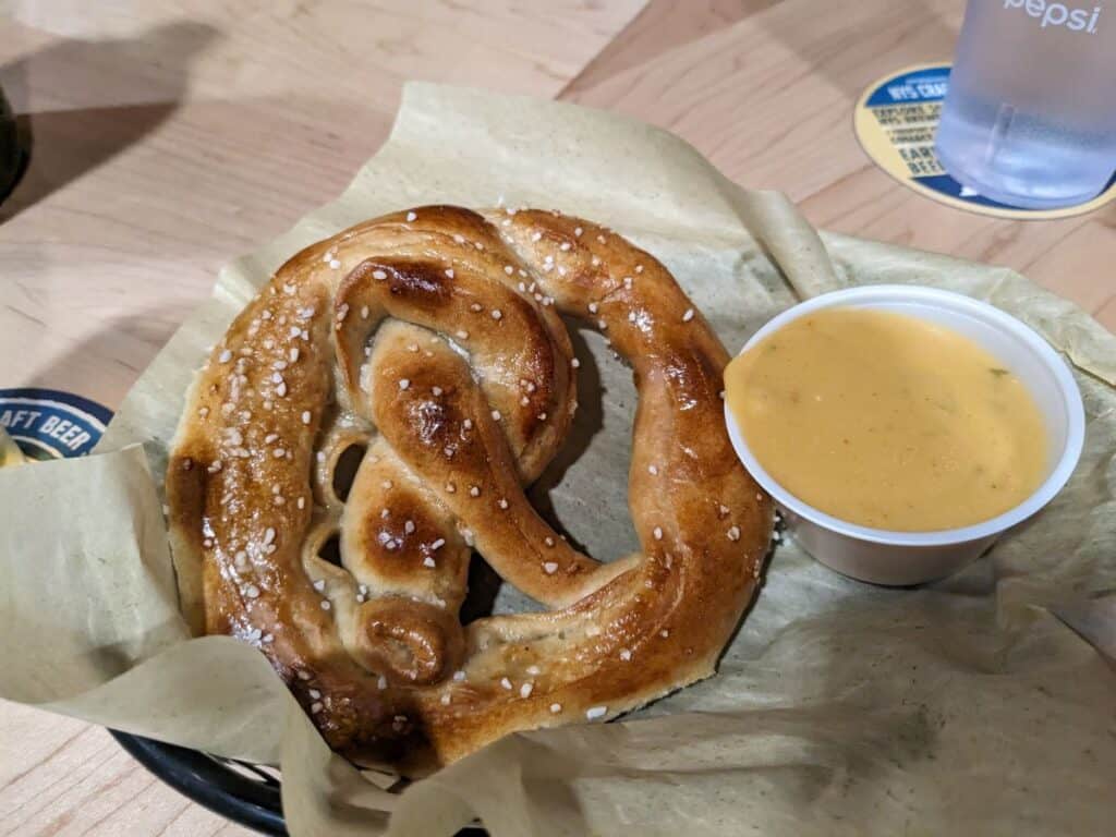 Soft pretzel with cheese sauce.