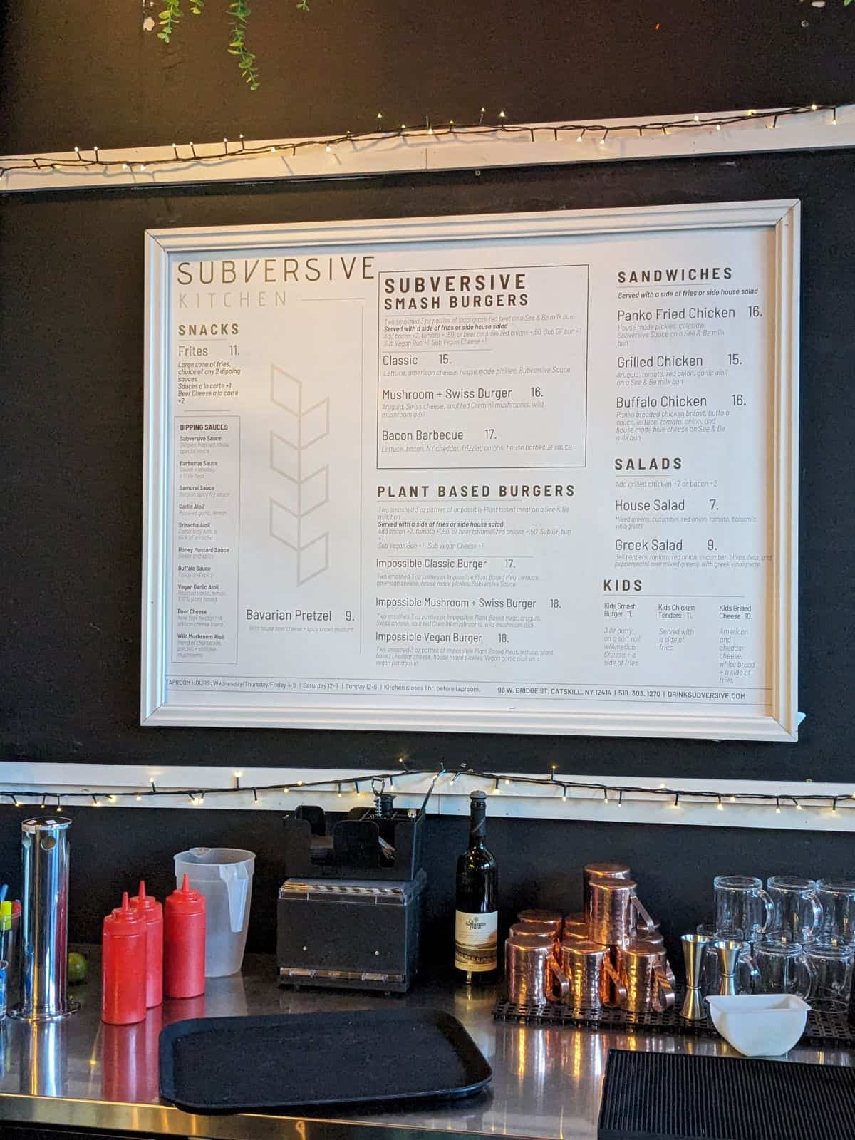 Food menu on the wall above the bar.