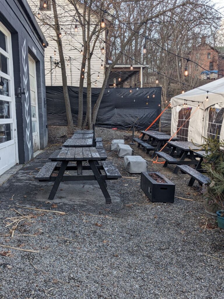 Another outdoor seating area with picnic tables.