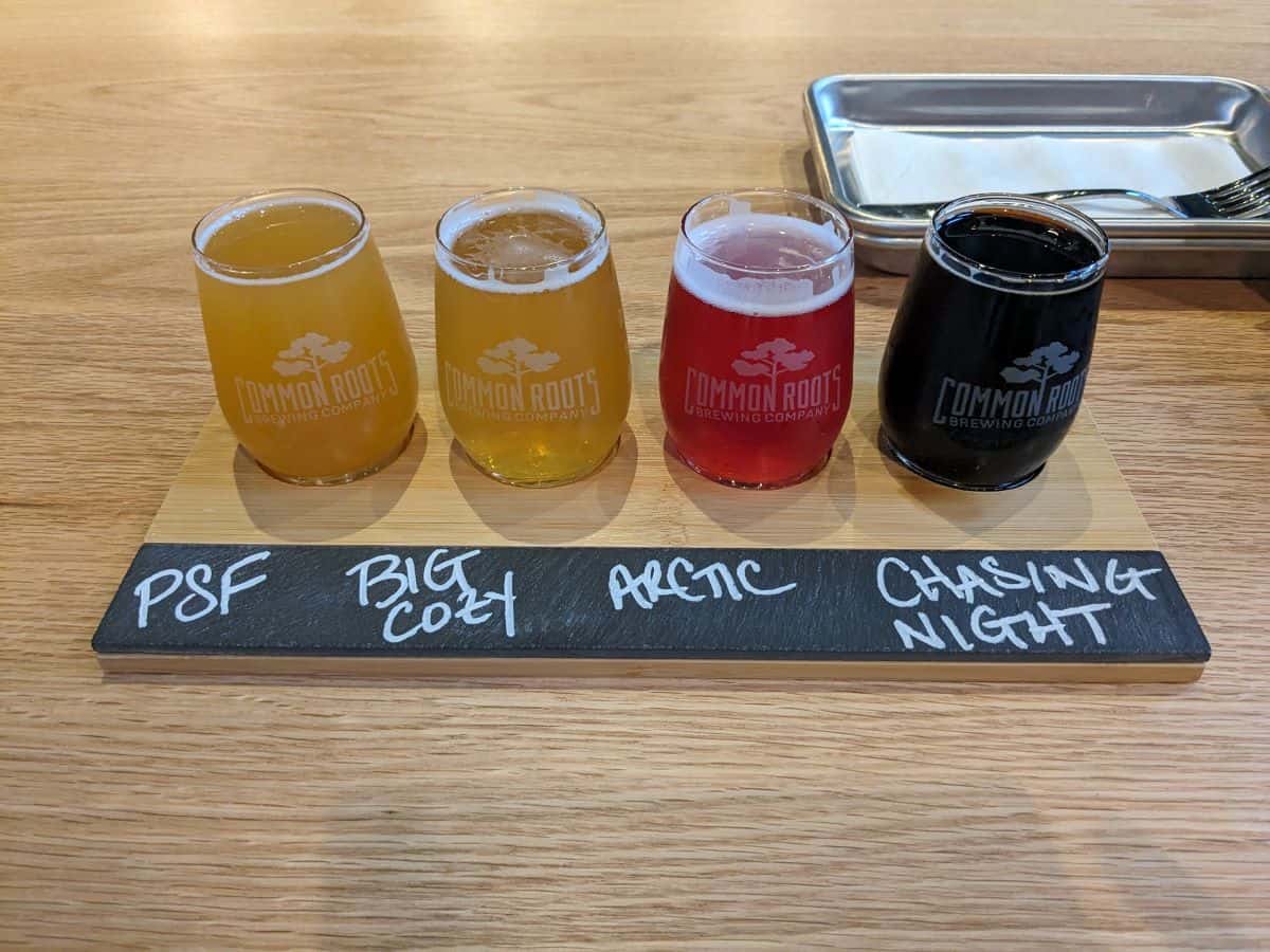 Flight of 4 beers on a table.