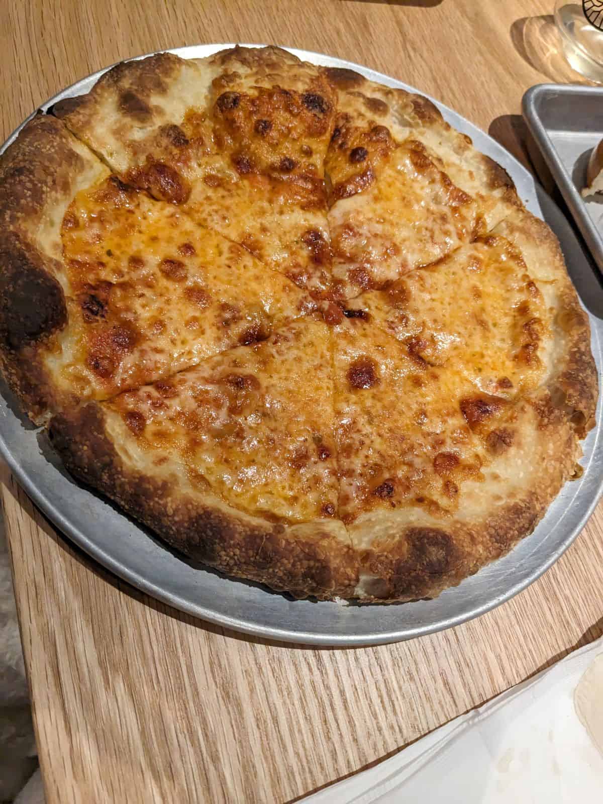 Cheese pizza on a table.