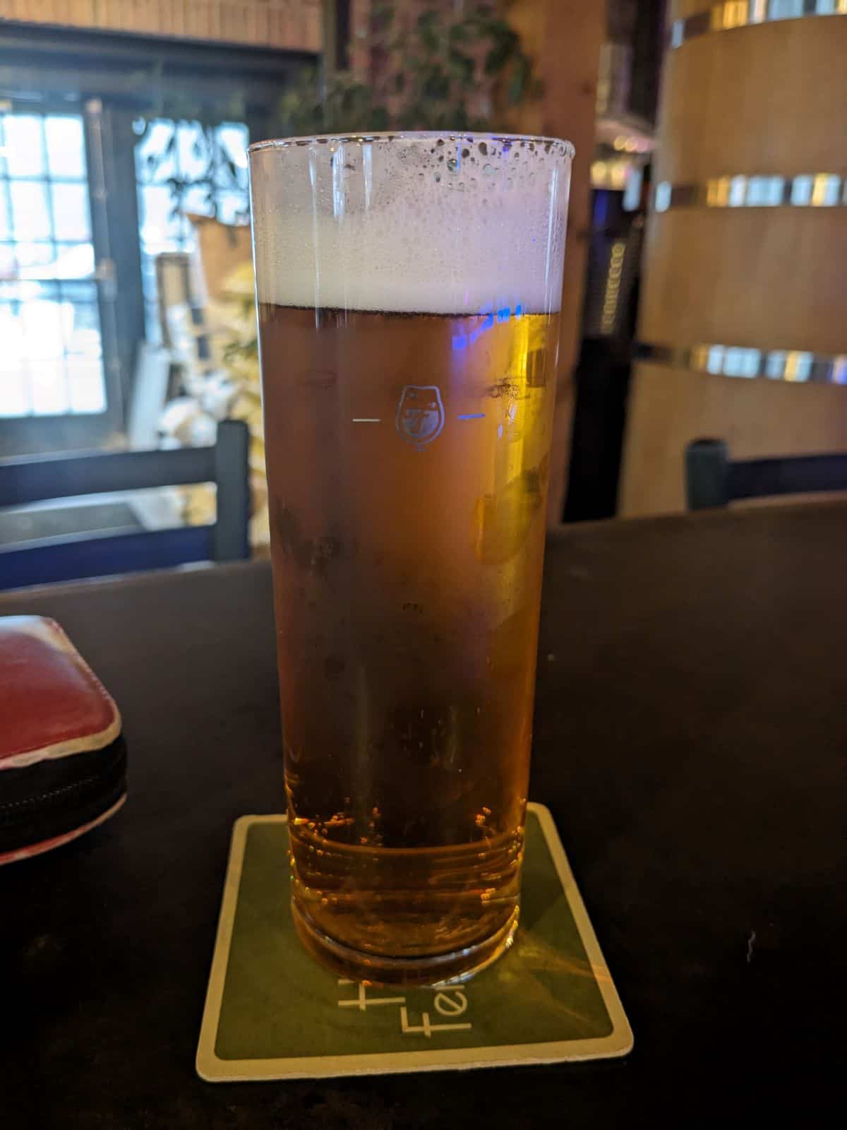 Glass of Vienna Lager on a table.