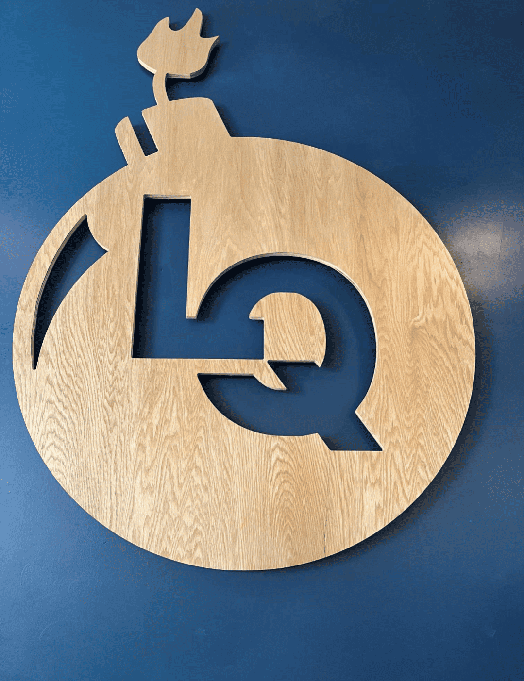 Large wooden Loaded Question bomb logo.