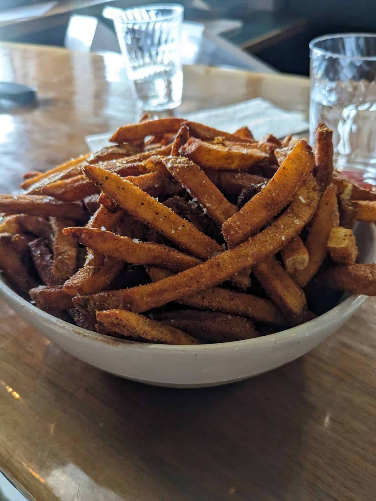 Bowl of french fries on the bar.