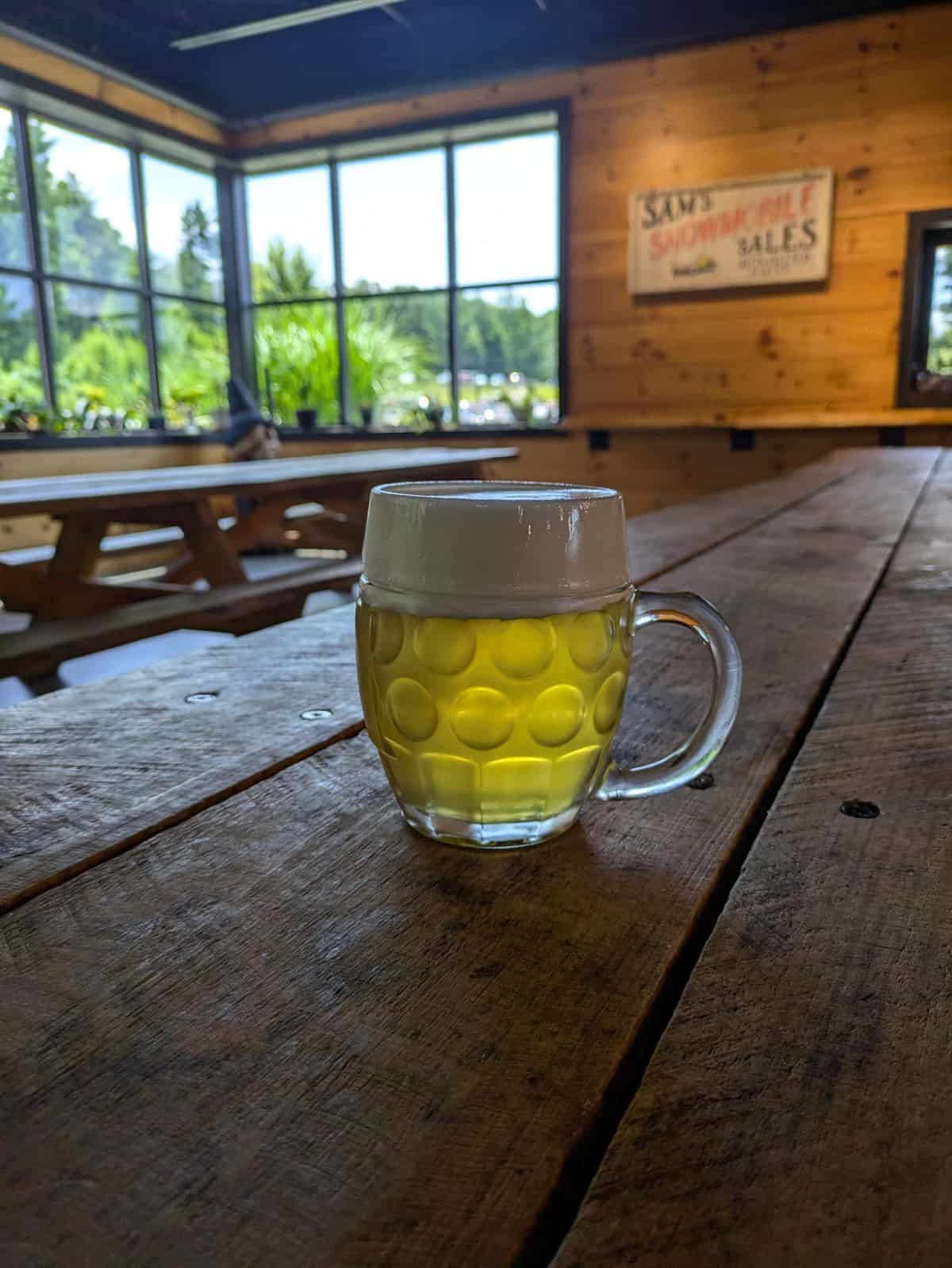 Mug of beer on a table.